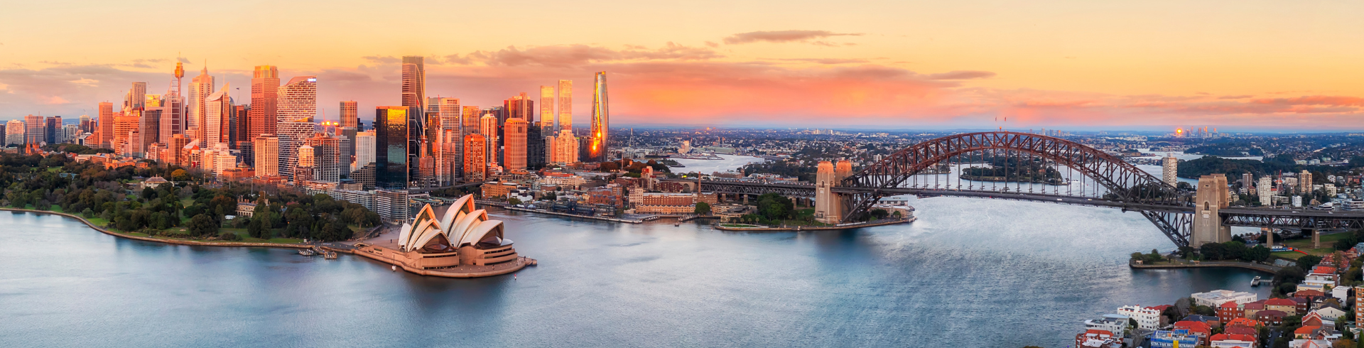 Aerial view of Sydney Harbour, which includes the Sydney Opera House and Harbour Bridge in the foreground, with the Sydney CBD in the background